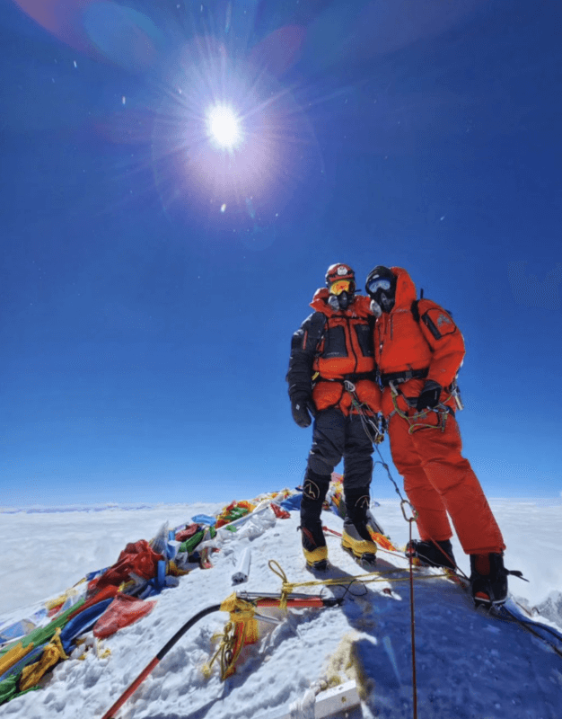 Guide Carla Perez and client Matt Greving standing on the summit of Mount Everest in 2024